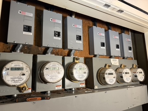 Multiple meters and associated electrical panels.