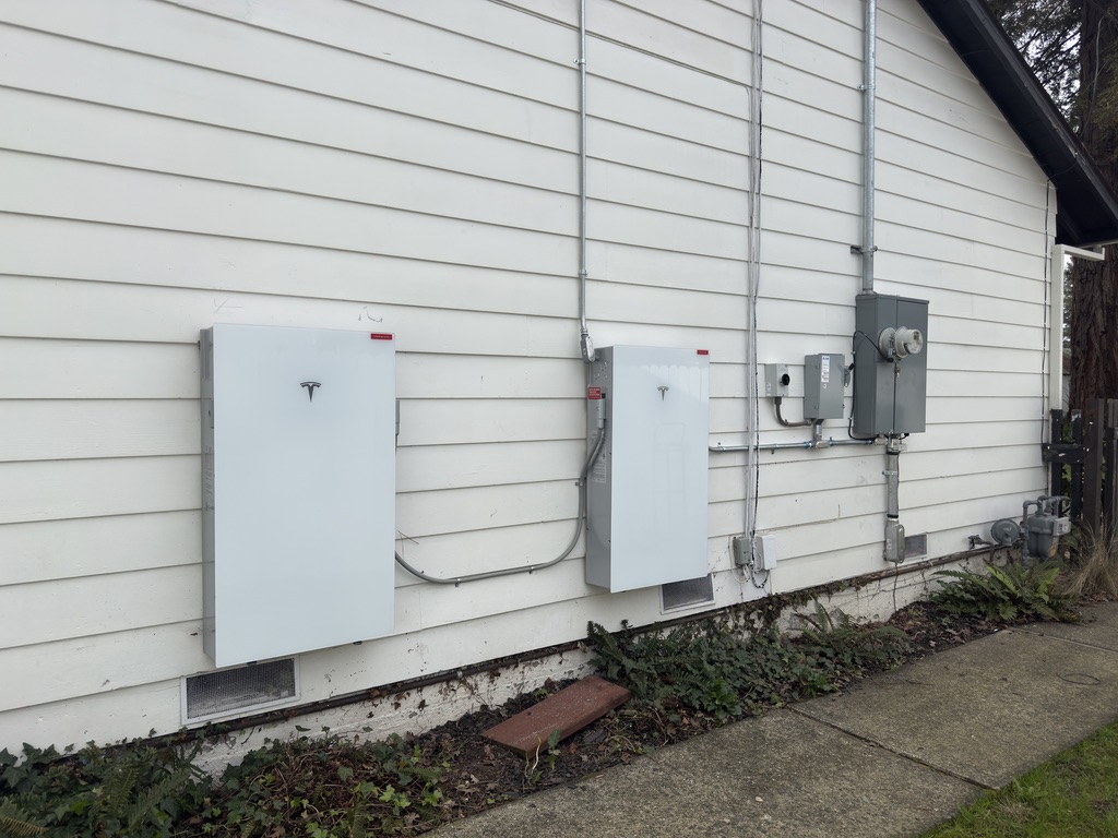 Tesla battery system mounted on a home exterior
